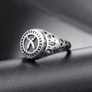 Macro detail of vintage stainless steel signet ring with engraved cross and hollow side