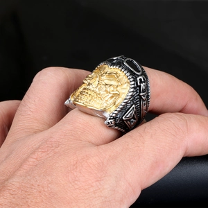 Detail of a biker skull ring in two-tone stainless steel on a model's hand