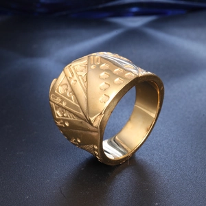 Macro detail of gold stainless steel ring featuring engraved poker cards royal flush design