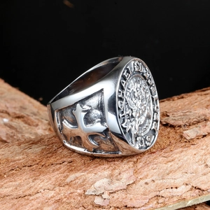 Macro detail of St. Michael vintage stainless steel signet ring with cross engraving
