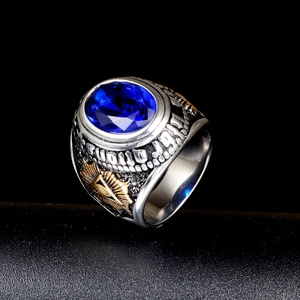 Macro shot of a vintage men's ring with a blue oval gemstone and golden eye detail
