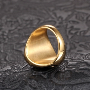 Detail of gold brushed titanium steel ring showing smooth polished inner surface texture