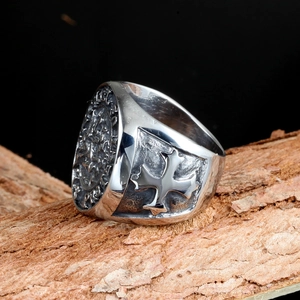 Vintage stainless steel knights ring featuring a relief maltese cross on tree bark
