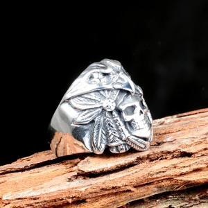 Vintage skull and eagle feather stainless steel ring for men on rustic wood background