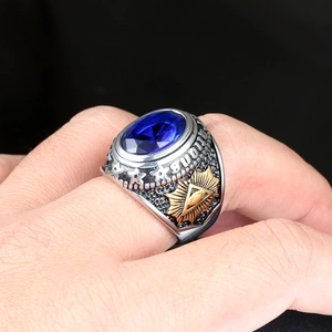 Macro view of blue gemstone men ring with masonic eye and sunburst carvings