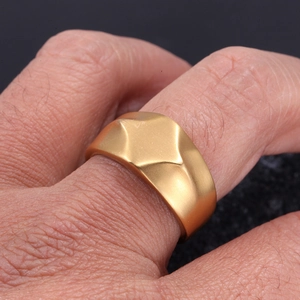Macro d'une bague pour homme en titane doré avec finition mate et design géométrique