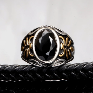 Men's vintage stainless steel ring with black oval gemstone and gold relief patterns