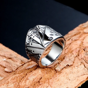 Mens vintage stainless steel poker ring with royal flush design on bark background