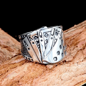 Macro detail of royal flush poker spades engraved on a vintage titanium steel ring
