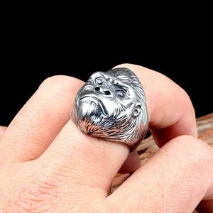 Macro shot of punk style stainless steel gorilla ring with vintage oxidation texture