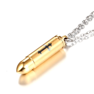 Brushed gold bullet pendant necklace with black cross engraving on a silver chain