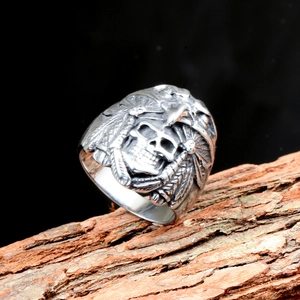 Vintage punk men's skull and eagle ring with retro feather textures on natural wood bark
