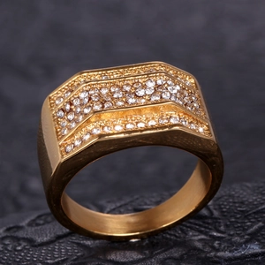 Macro shot of gold stainless steel men's ring with three-tier rows of sparkling zircon stones