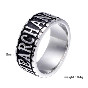 Macro view of 8mm stainless steel ring with black aged finish and SEARCHING embossing