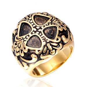 Vintage stainless steel skull ring with gold finish and tribal textured engravings
