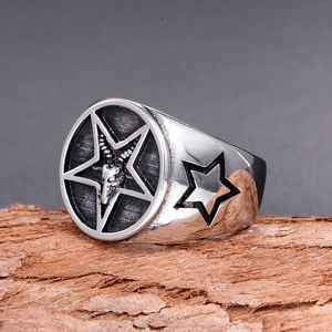 Vintage stainless steel signet ring with Baphomet sheep head and pentagram on tree bark