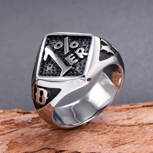 Men's stainless steel biker ring with 1%ER emblem and number 13 on a wooden stand