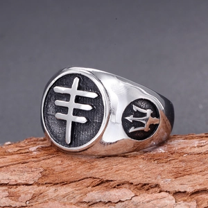 Macro view of stainless steel men's ring with black cross pattern and trident detail