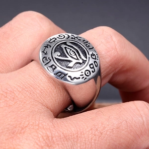 Close-up of vintage titanium steel ring featuring Eye of Horus and Egyptian symbols