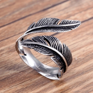 Vintage stainless steel open feather ring with antique finish on wooden background