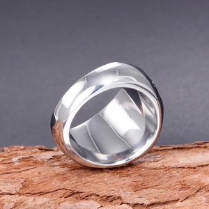 Polished silver geometric faceted stainless steel band ring for men on wood