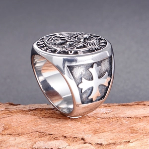 Detail of St. Michael signet ring in vintage steel featuring cross and Protect Us engraving