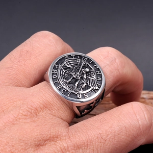 Macro shot of St. Michael engraving and cross detail on vintage stainless steel men's ring