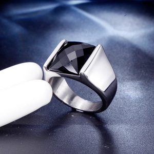 Macro shot of men's stainless steel ring with a large faceted black gemstone inlay