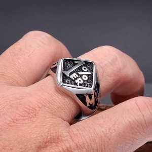 Macro detail of men's stainless steel MC 1%ER motorcycle club ring with vintage finish