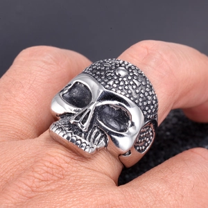 Macro shot of a punk skull ring in vintage stainless steel worn on a finger