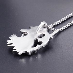Macro view of gothic reaper pendant in silver stainless steel with box chain detail