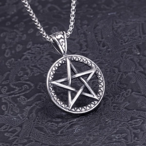 Macro view of vintage stainless steel pentagram pendant with oxidized silver finish