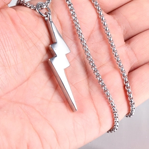 Detailed view of polished stainless steel lightning bolt pendant on a round box chain