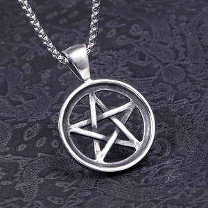 Macro shot of stainless steel pentagram star pendant with interlocking pattern detail