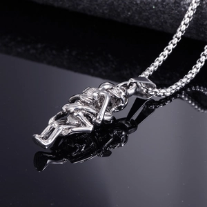 Gothic stainless steel skull lovers pendant necklace with durable box chain on black surface