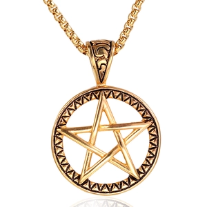 Detail of vintage gold pentagram pendant with engraved textures and box chain necklace