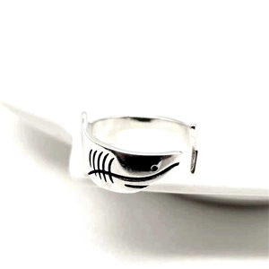 Dettaglio macro di un anello regolabile in argento con motivo a lisca di pesce nero