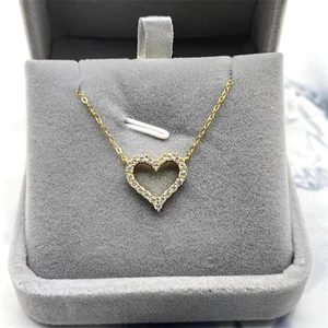 Gold S925 sterling silver hollow heart necklace with diamonds in a grey velvet box