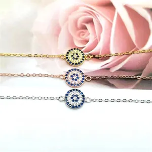 Detailed view of three S925 silver evil eye bracelets in gold, rose gold and silver finishes
