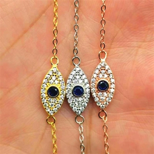 Detailed view of evil eye bracelets in gold, silver, and rose gold finishes with blue stones