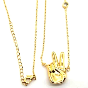 Gold-plated peace sign gesture pendant necklace with sparkling cubic zirconia accent