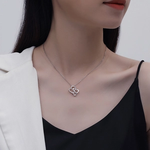 Close-up of S925 sterling silver infinity double heart necklace worn by a fashion model