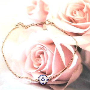 Detail of rose gold S925 silver bracelet featuring blue devil's eye and zircons