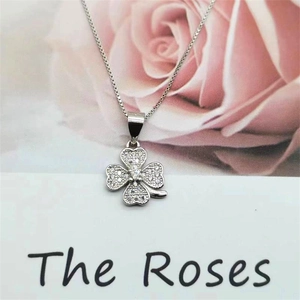 Macro shot of silver S925 four-leaf clover pendant with sparkling cubic zirconia inlay