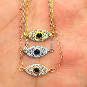 Detailed close-up of three evil eye bracelets in gold, silver, and rose gold plating