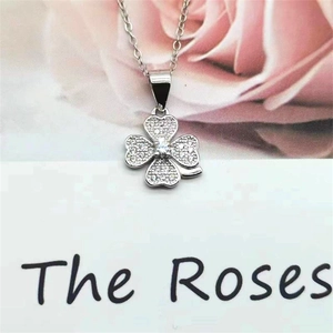 Detail of S925 sterling silver four-leaf clover pendant featuring pavé-set clear stones
