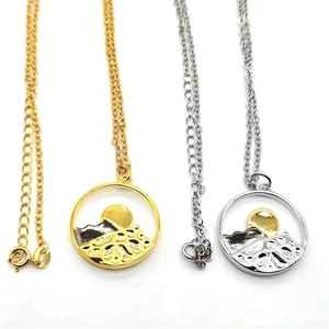 Detail view of two-tone mountain necklaces in gold and silver finish with circular pendants