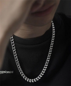 Detail shot of heavy S925 sterling silver Cuban link chain worn by male model