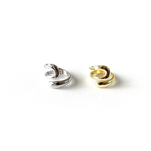 Macro shot of irregular hollow water-drop open rings in polished silver and gold finishes