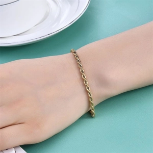 Detailed close-up of a golden rope chain bracelet worn on a wrist for a stylish look